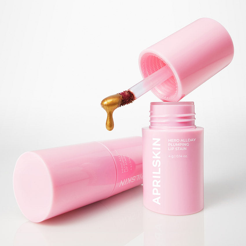 APRILSKIN Hero All Day Plumping Tint : flacon rose et embout applicateur, goutte de texture, visuel produit sur fond clair.