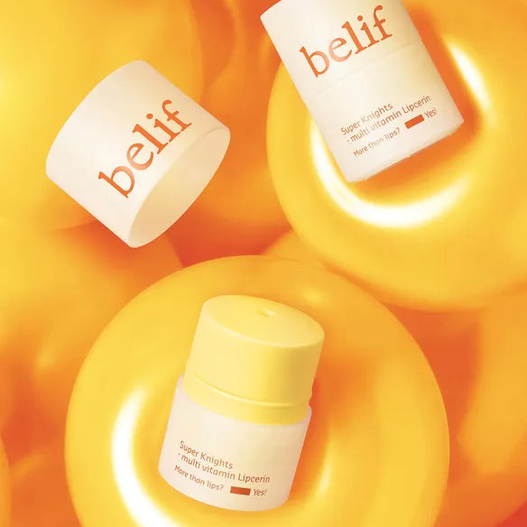 BELIF Super Knight Multi Vitamin Lipcerin de la marque belif, sur fond orange lumineux, flacon et emballages visibles