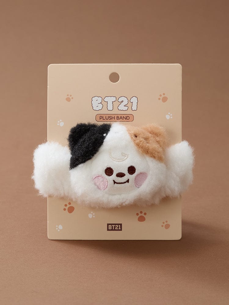 BT21 BABY MORE FLUFFY FACE PLUSH BAND, peluche BT21 sur carte, visage du personnage du chat, fond beige décoratif.