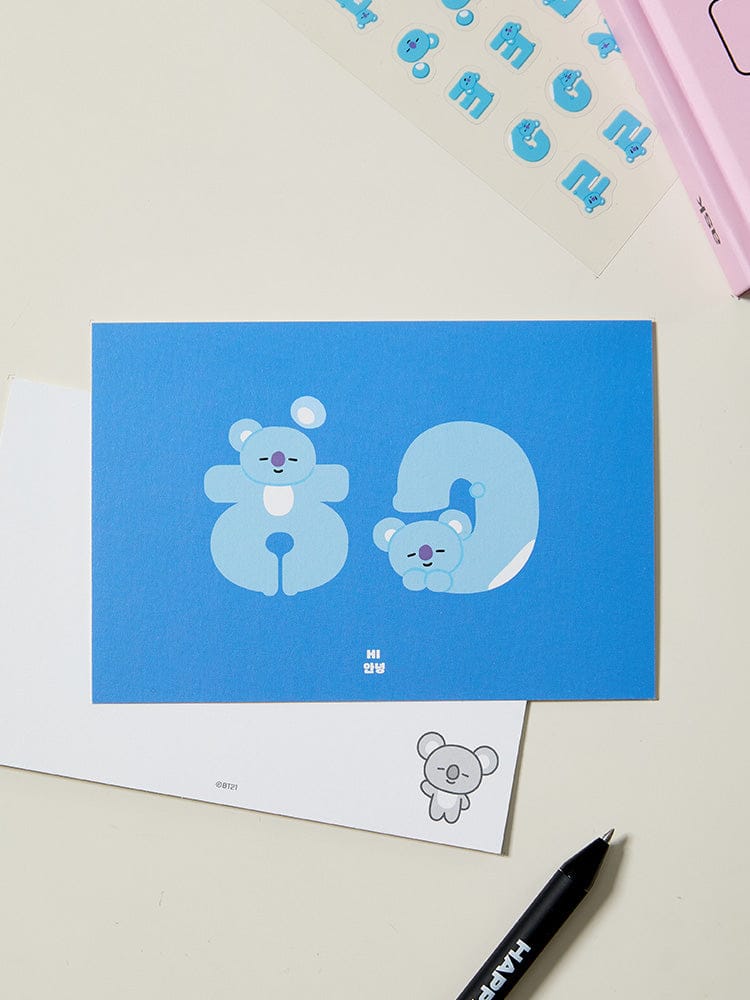 BT21 HANGEUL POSTCARD SOUVENIR, carte postale officielle LINE FRIENDS, visuel Hangeul bleu avec personnages BT21 sur bureau