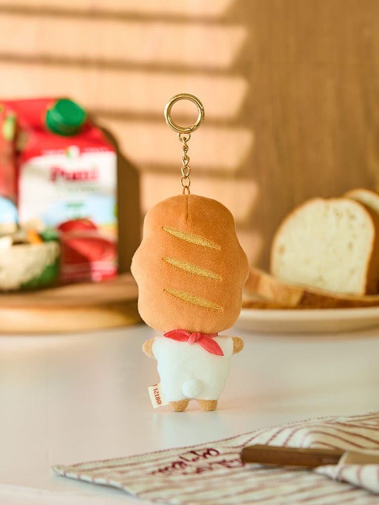 BT21 RJ BABY PLUSH KEYRING BAKERY SHOP : porte-clés RJ alpaga dans une ambiance boulangerie, décor cookies et pain.