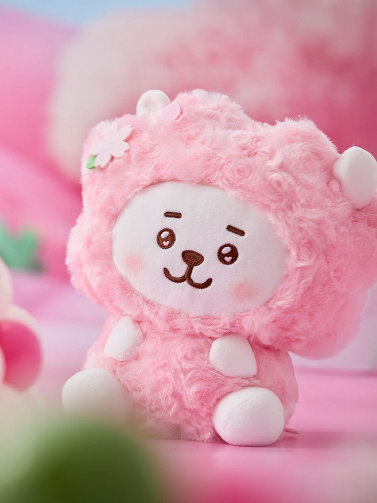 BT21 RJ BABY SITTING PLUSH SPRING FAIRY, peluche officielle LINE FRIENDS rose, alpaga assis devant décor pastel.