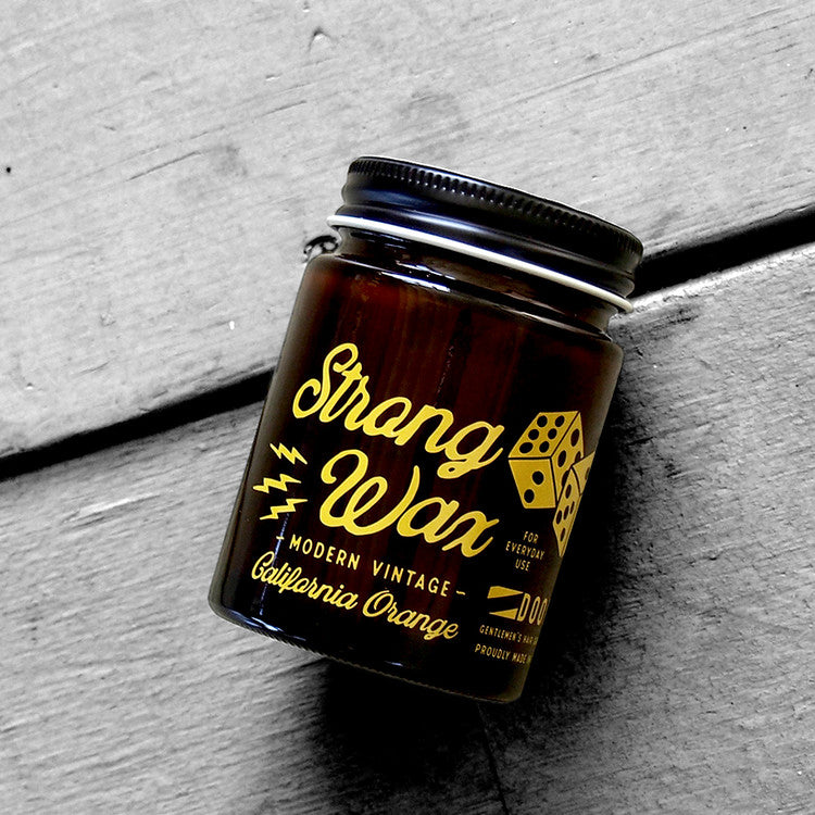 DOORS California Beach Orange Strong Wax 80g, pot de cire Strang Wax sur fond béton, ambiance plage Californie, orange