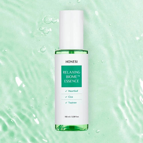 HONESI Relaxing Biome Ampoule Essence 100ml, flacon vert sur fond aquatique apaisant, gouttes et bulles.
