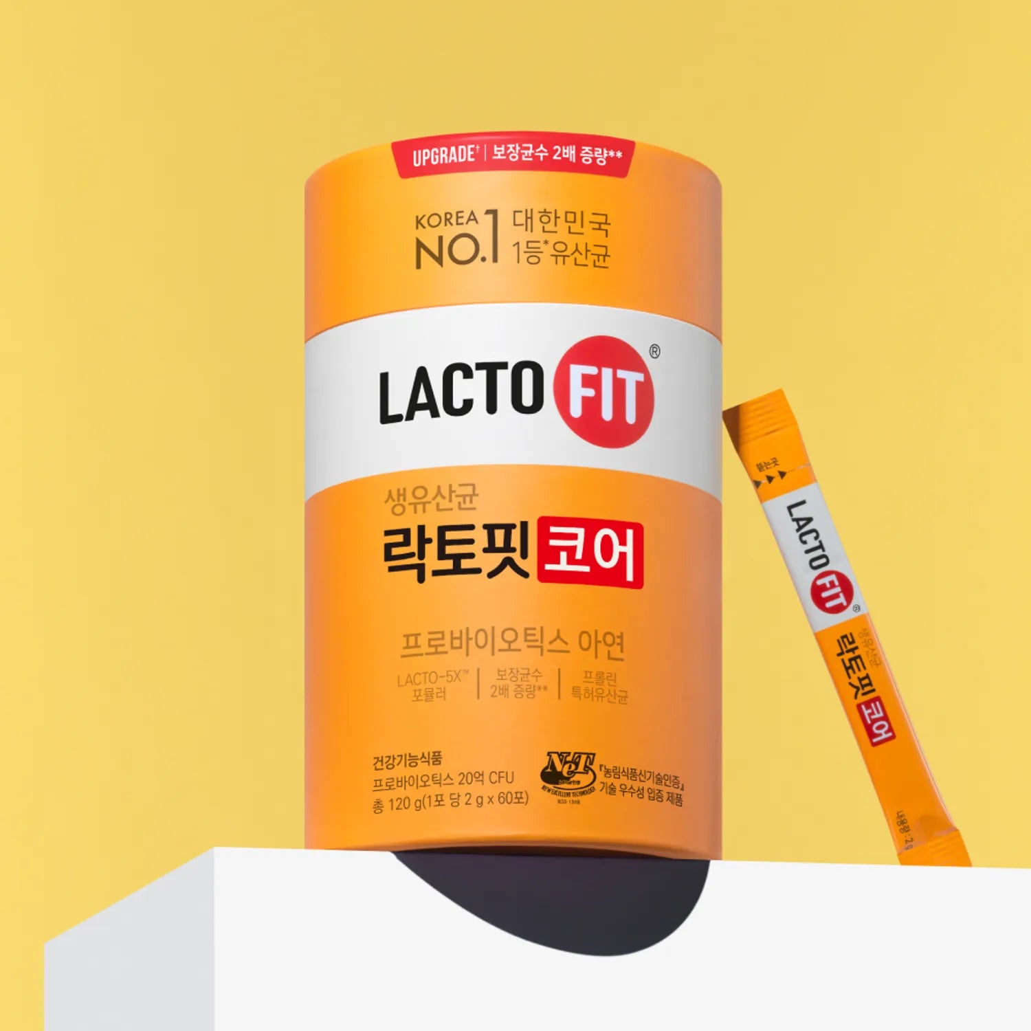 LACTO-FIT Probiotics Core 60 Sticks LACTO-FIT, pack orange et bâtonnets probiotiques sur fond jaune en studio.