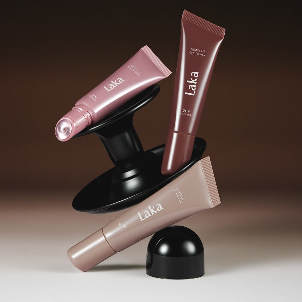 Produits LAKA Fruity Lip Glossionner disposés artistiquement, mettant en valeur leurs designs élégants et variés en teintes naturelles.