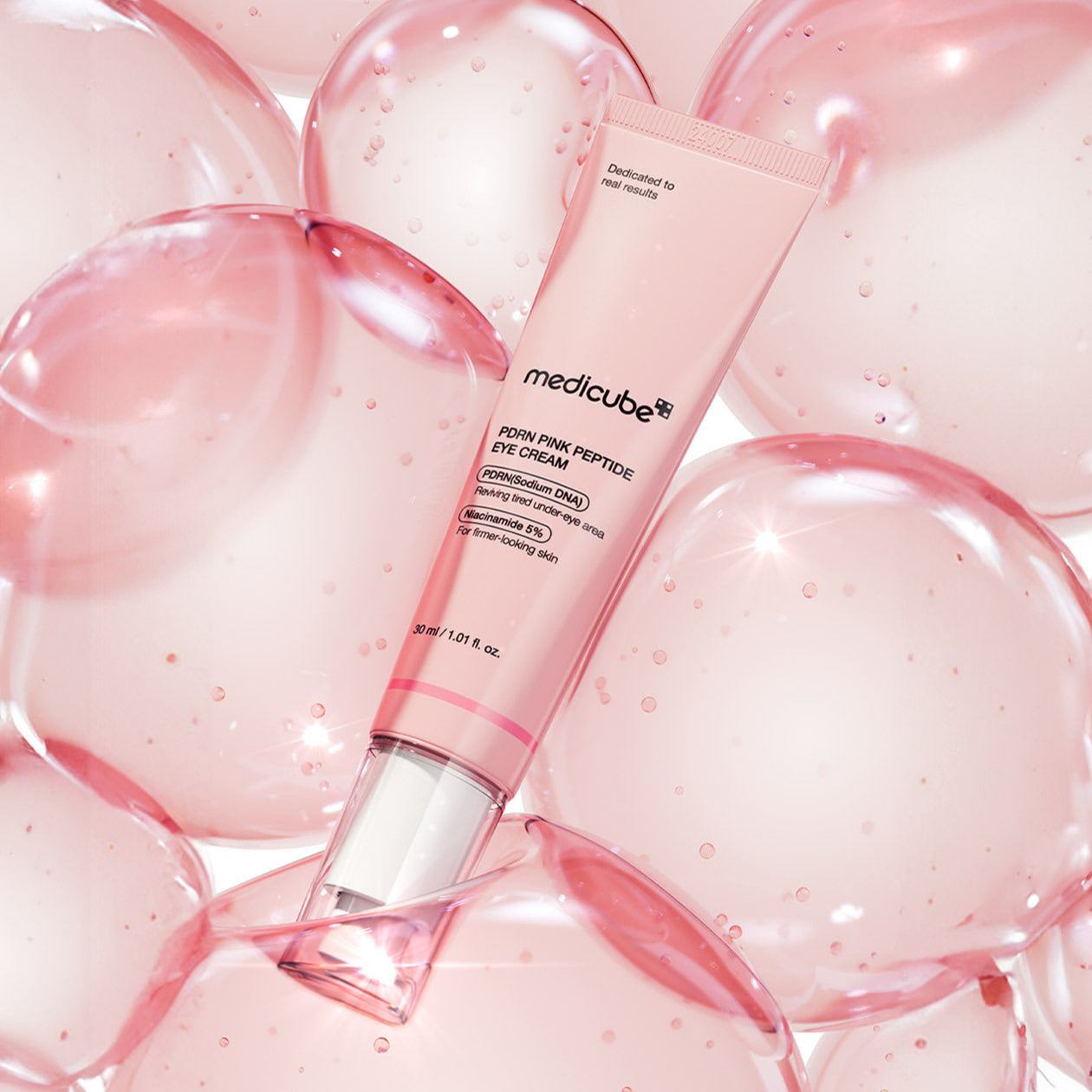 MEDICUBE PDRN Pink Peptide Eye Cream 30ml, tube rose de la marque mediceube sur fond bulles roses, peau hydratée