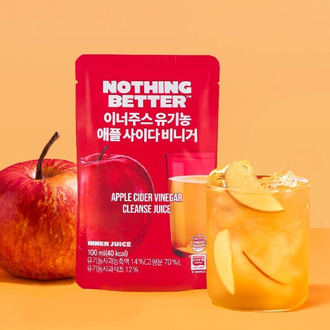NOTHING BETTER Inner Juice Apple Cider Vinegar Cleanse Juice (X24) : sachet rouge, pommes et verre de jus sur fond orange