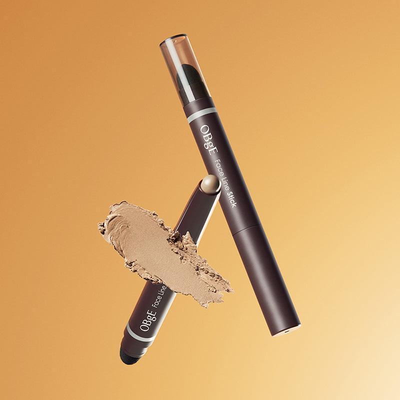 OBGE Face Line Stick de la marque OBGE, sur fond orange, avec texture de maquillage et application sur le visage