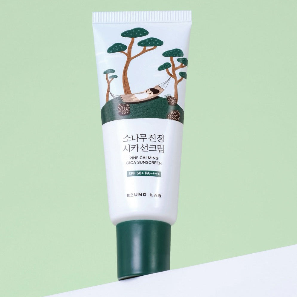 ROUND LAB Pine Calming Cica Sunscreen 40ml sur fond vert, tube crème solaire. Protection solaire et apaisement pour la peau.