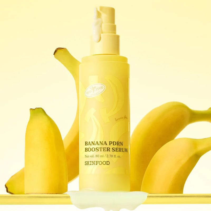 SKINFOOD Banana PDRN Booster Serum 80ml, flacon jaune sur fond crème avec bananes tranchées, marque SKINFOOD visible.