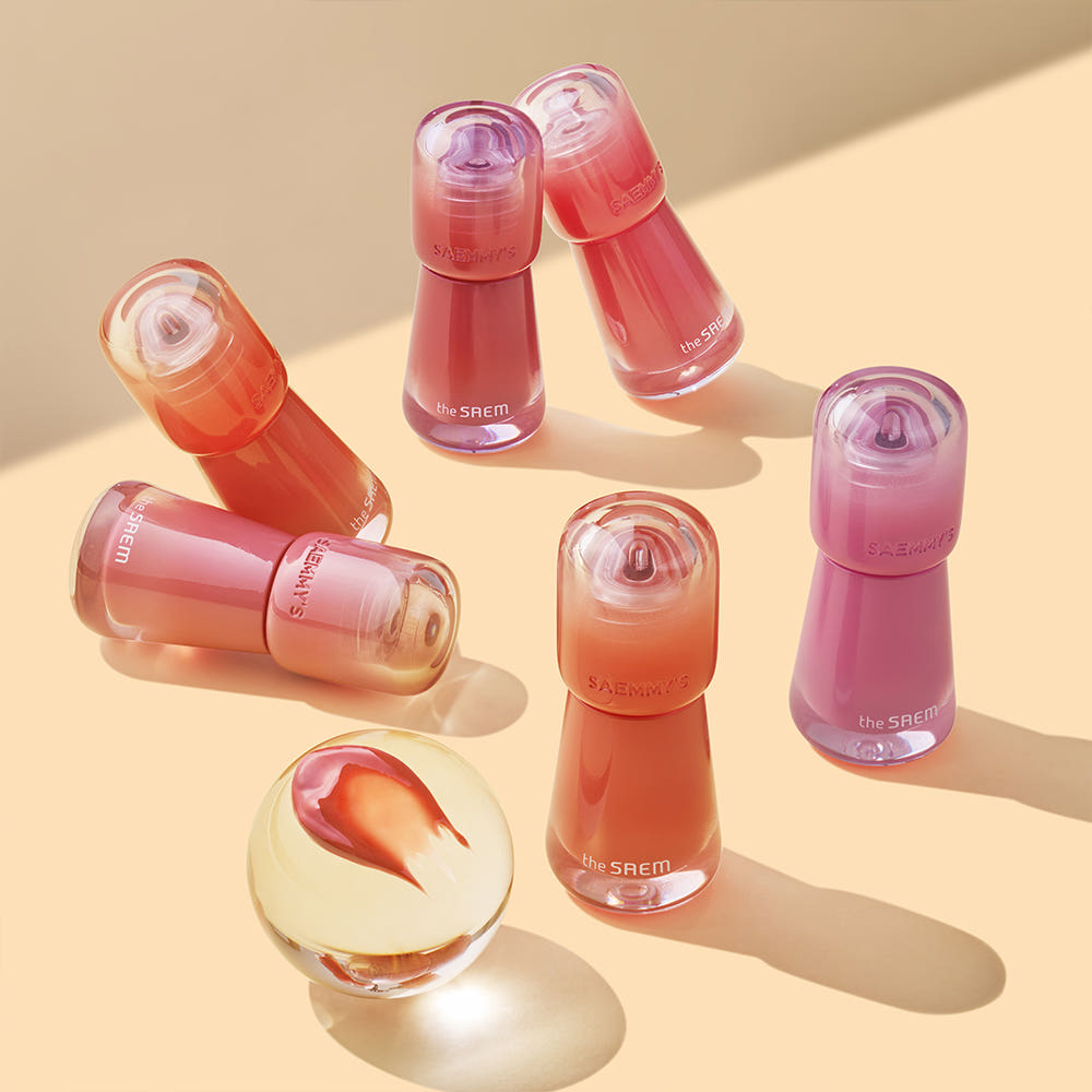 THE SAEM Saemmy's Aid Shot Tint : flacons colorés de la marque THE SAEM sur fond beige, ambiance cosmétique.