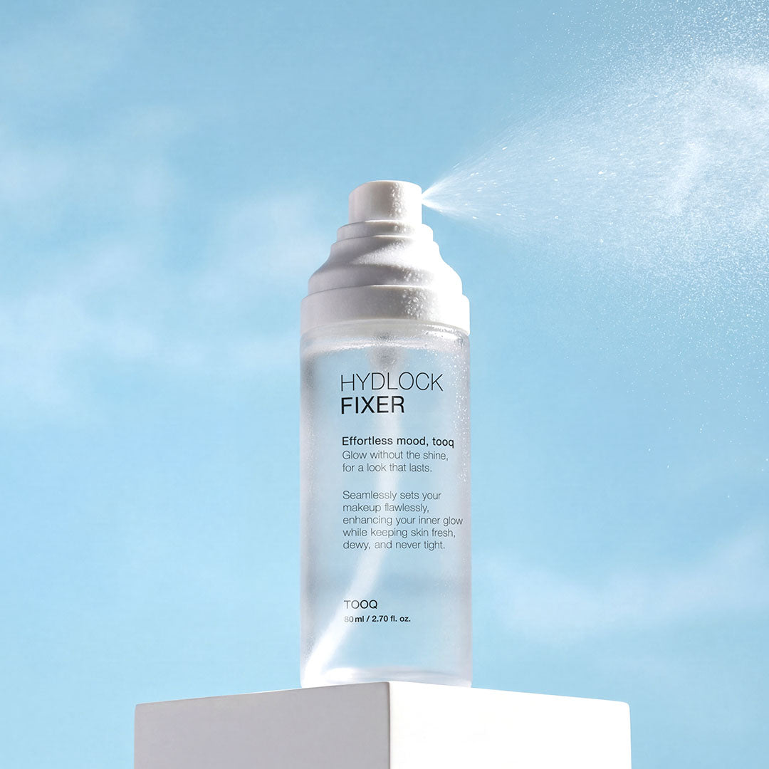 TOOQ Hydrock Fixer 80ml, flacon Hydlock sur fond ciel bleu, produit de la marque TOOQ en contexte visuel.