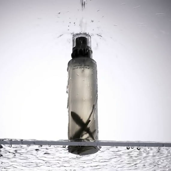 WHAMISA Organic Herb Fermented Olive Leaf Mist 100ml, spray brun sur fond blanc avec gouttes d’eau, marque WHAMISA.