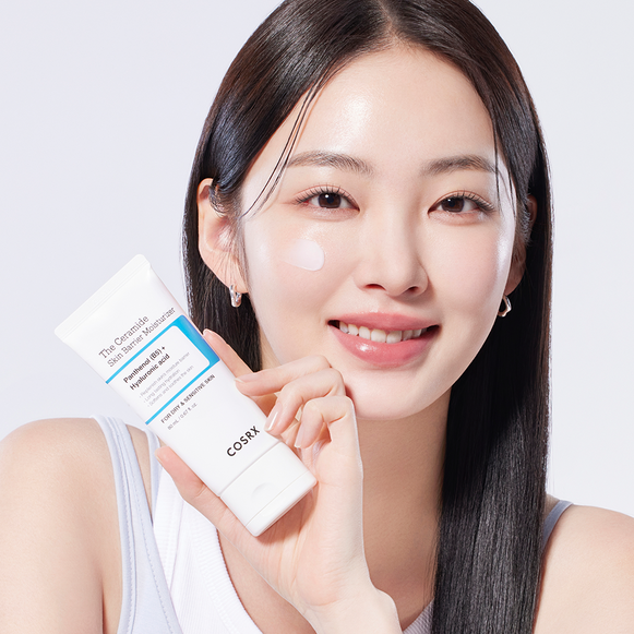 Model holding COSRX The Ceramide Skin Barrier Moisturizer, showcasing its application. Available at Ma Petite Corée for enhanced skin protection.