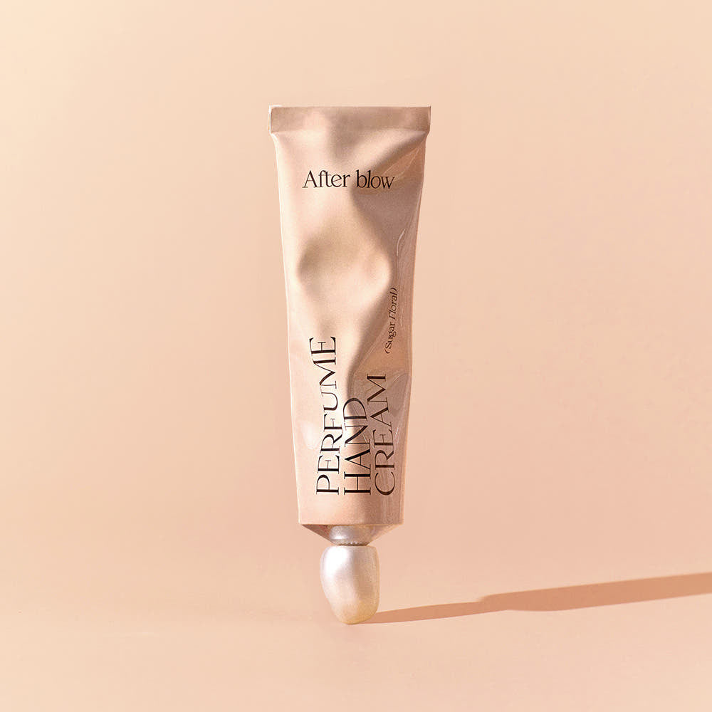 AFTER BLOW Perfume Hand Cream 50ml, tube crème parfumée de la marque After blow sur fond beige, photo produit.
