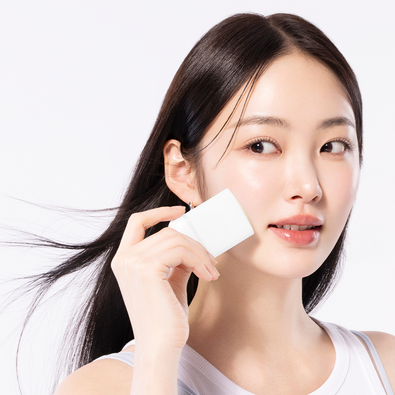 Woman applying COSRX Airy-Light Invisible Sun Stick SPF50+ from Ma Petite Corée for sun protection.