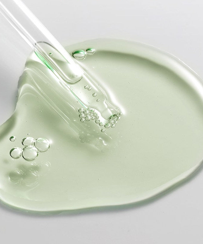 ACWELL Tea Tree Blemish Control PDRN Ampoule 80ml : sérum à l’huile d’arbre à thé, gouttes vertes sur fond clair.