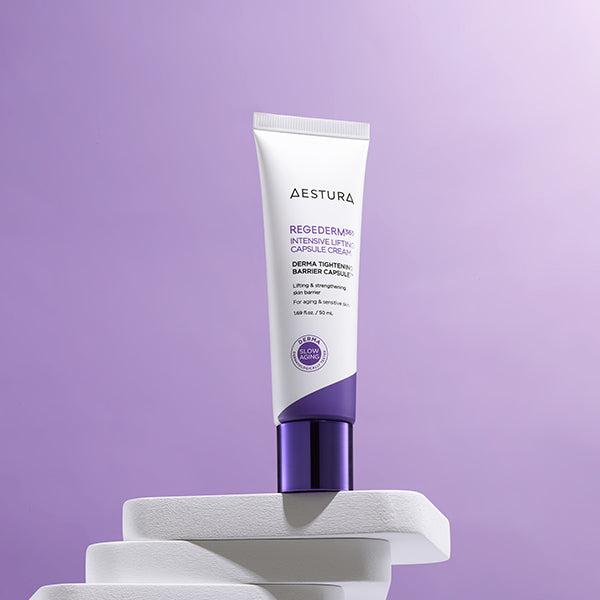 AESTURA Regederm365 Intensive Lifting Capsule Cream 50ml, tube sur socle blanc, fond violet, produit beauté en studio.