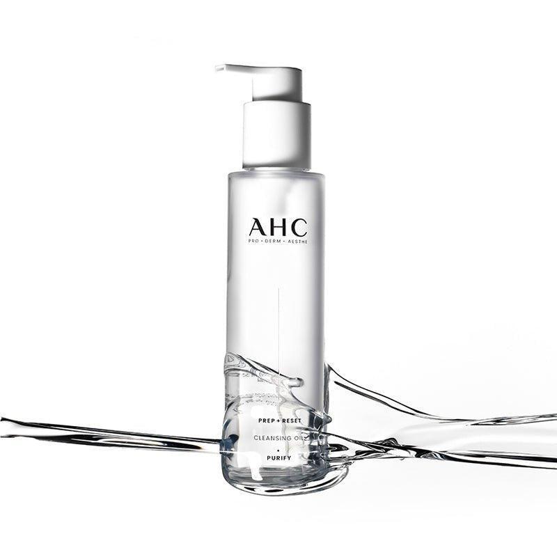 AHC Prep Reset Cleansing Oil 125ml : flacon AHC blanc sur fond clair avec éclaboussures d'huile, produit nettoyant