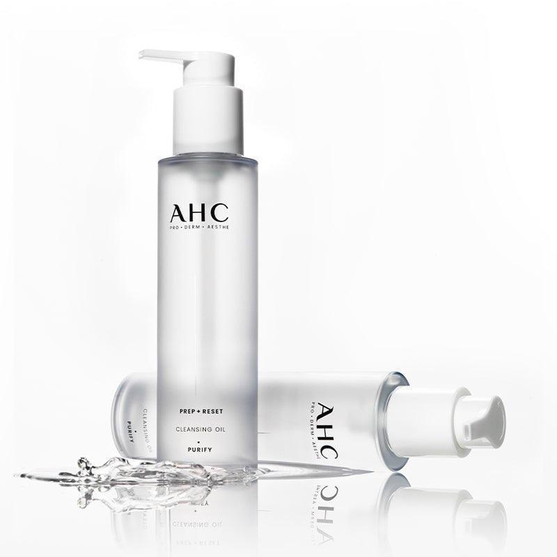 AHC Prep Reset Cleansing Oil 125ml : flacon pompe AHC sur fond blanc, avec éclaboussures d’huile et eau.