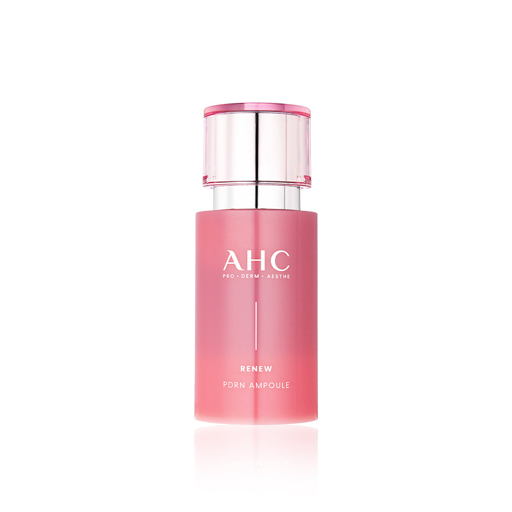 Décris l'image en français: AHC Renew PDRN Ampoule 30ml AHC, flacon rose sur fond blanc, produit cosmétique en gros plan.