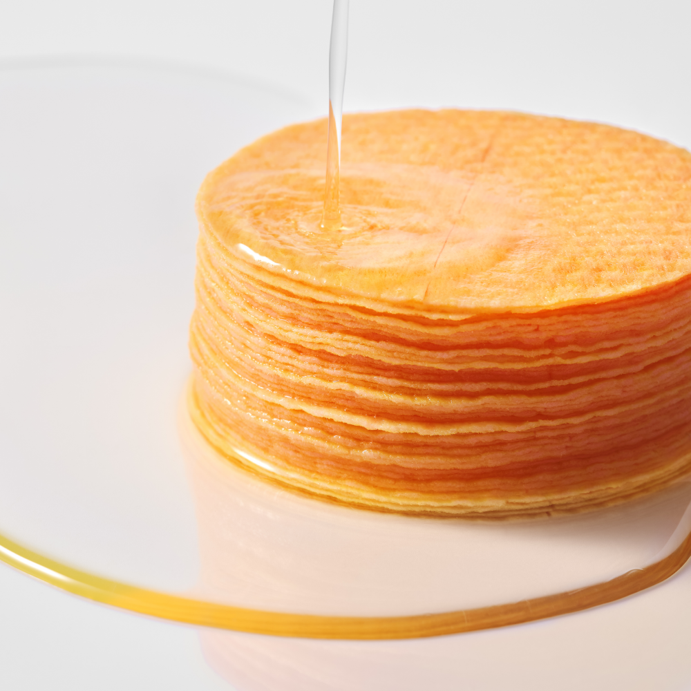 ANUA Vitamin C + Niacin Tone Up Blemish Pad 60p 185ml, marque ANUA, pads superposés, sérum coule sur un stack.