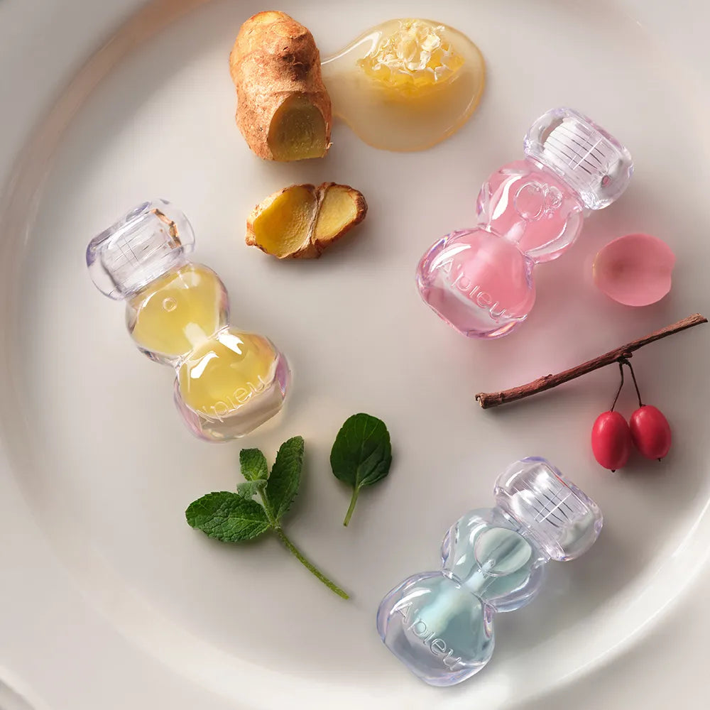 A'PIEU Jelly Honey Lip Oil 4g, marque A'PIEU : huile à lèvres en flacons roses et jaunes sur fond blanc, ambiance douceur