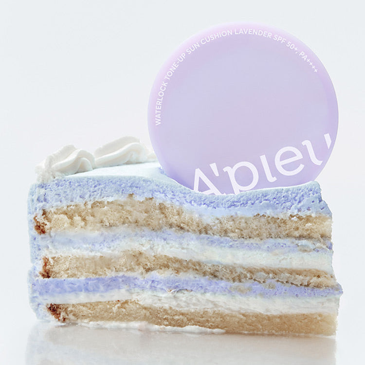 A'PIEU Waterlock Tone-Up Sun Cushion Lavender 15g, produit en packaging lavande sur un gâteau en fond blanc.