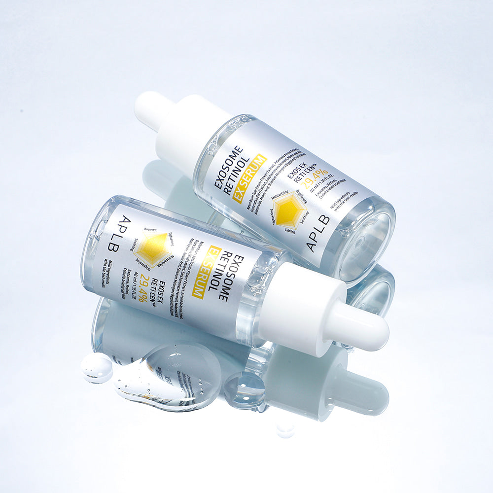 APLB Exosome Retinol EX Serum 40ml APLB sur fond clair avec sérums et bulles, photo produit en contexte beauté.