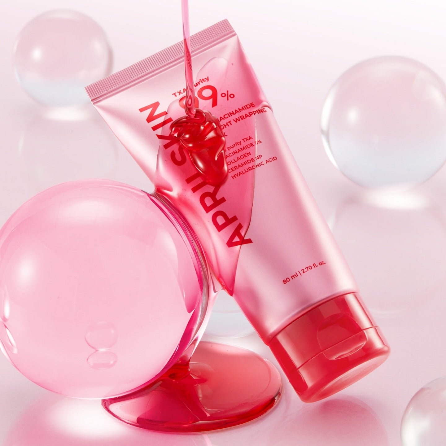 APRILSKIN TXA Niacinamide 99 Deep Cleanser 120g de marque APRILSKIN, tube rose sur fond bulles, contexte visuel skincare