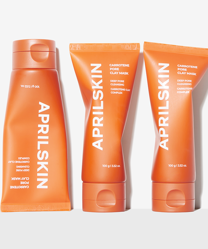 APRILSKIN Carrotene Pore Clay Mask d’APRILSKIN, pots et tubes orange sur fond blanc, vue produit.