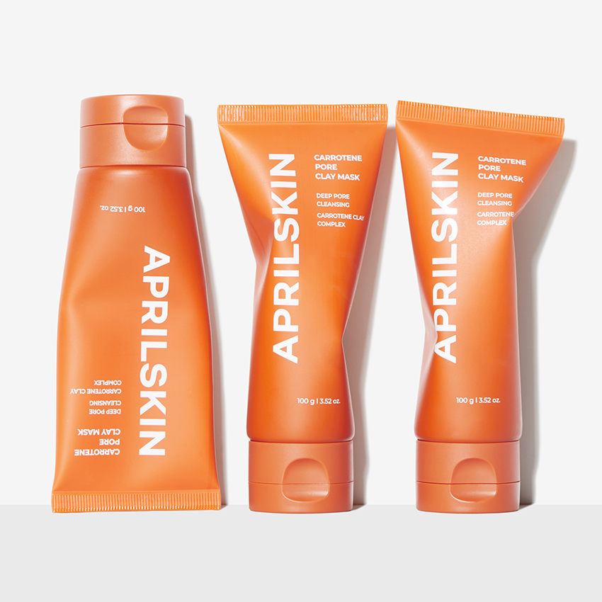 APRILSKIN Carrotene Pore Clay Mask d’APRILSKIN, pots et tubes orange sur fond blanc, vue produit.
