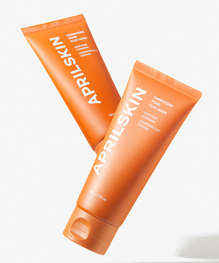 Décris l'image en français : APRILSKIN Carrotene Pore Clay Mask d'APRIL SKIN, masque à l'argile orange sur fond clair.