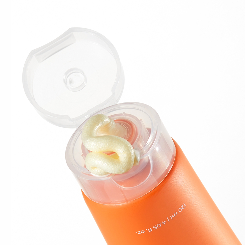 APRILSKIN Real Carrotene Acne Foam Cleanser 120ml d’APRIL SKIN : flacon orange ouvert, mousse visible, fond blanc.