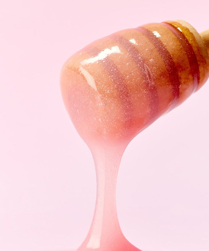 ARENCIA  Honey Glazed Collagen Lip Mask 15g, pot de masque à la texture miel brillante sur fond rose, vue gros plan.