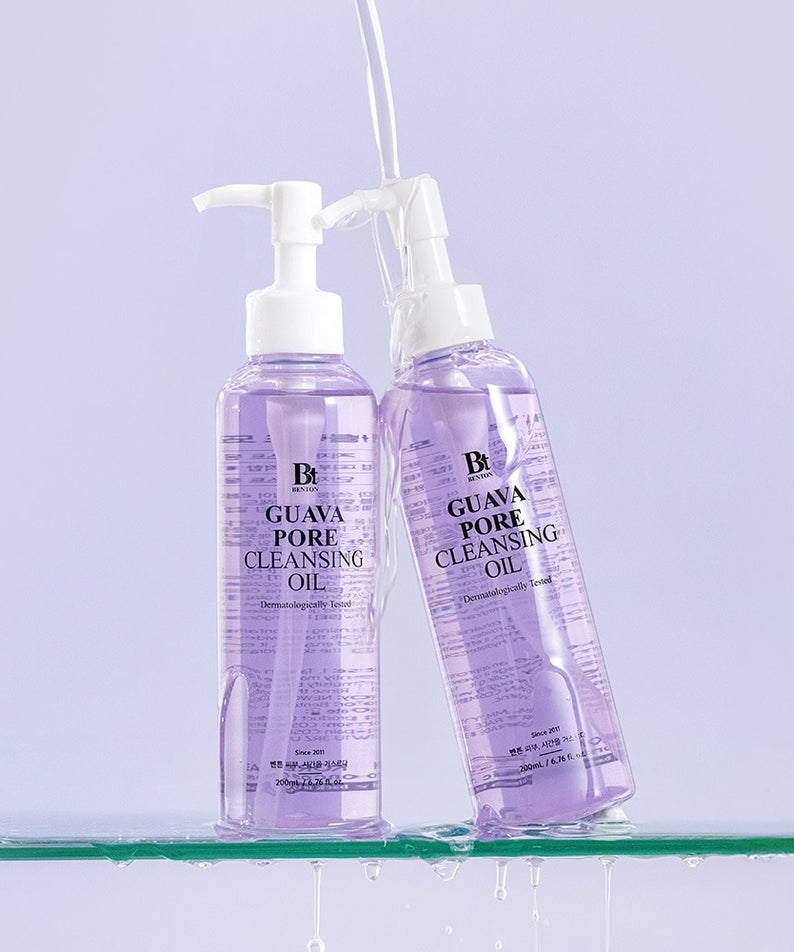 BENTON Guava Blackhead Pore Cleansing Oil 200ml, deux flacons avec pompe sur fond violet, contexte beauté