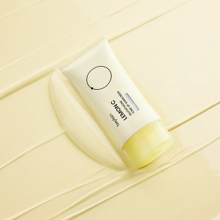 BEPLAIN Lemon Seed Glutathione Tone-up Sun Cream 50ml, marque BEPLAIN, tube crème sur fond jaune ensoleillé.