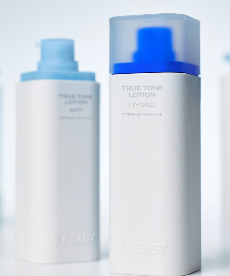 B.READY True Tone Lotion 2.0 40ml, flacons cosmétiques en arrière-plan blanc et bleu, marque B.READY, contexte studio.