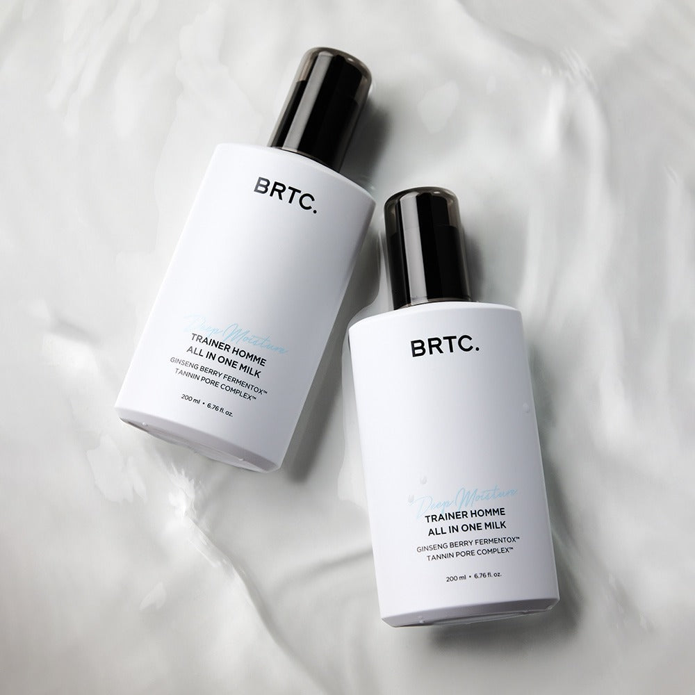 BRTC Trainer Homme ALl-in-One Milk 200ml de BRTC : flacons sur tissu blanc, contexte cosmétique homme.