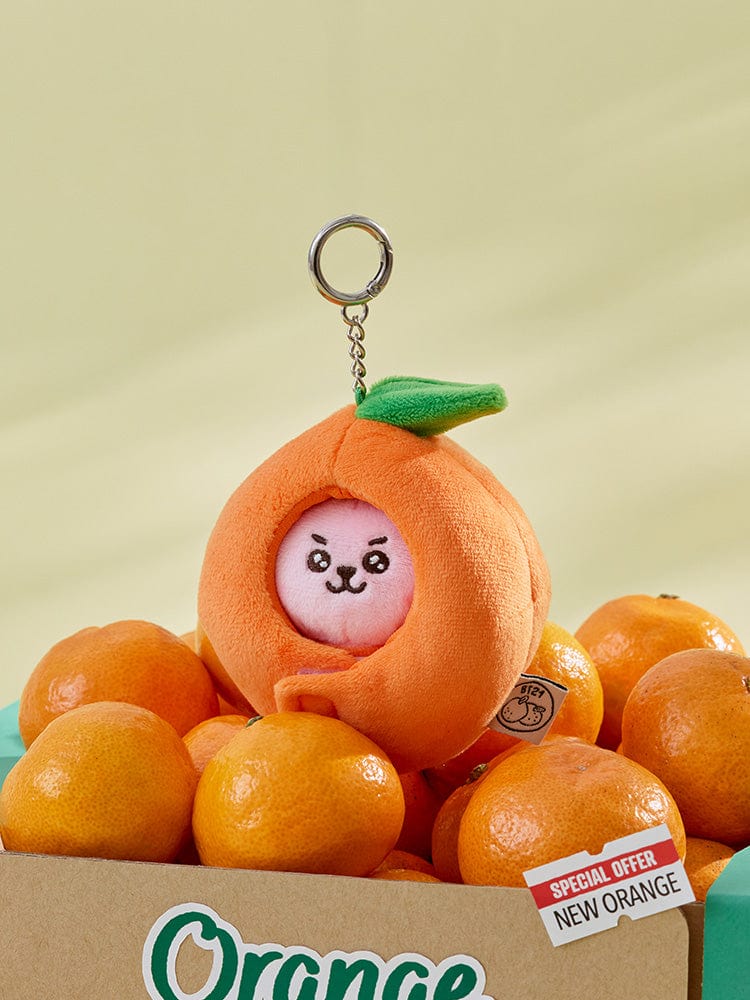 BT21 COOKY BABY PLUSH KEYRING ORANGE PARTY, porte-clés peluche orange LINE FRIENDS sur présentoir en fête, fan K-pop