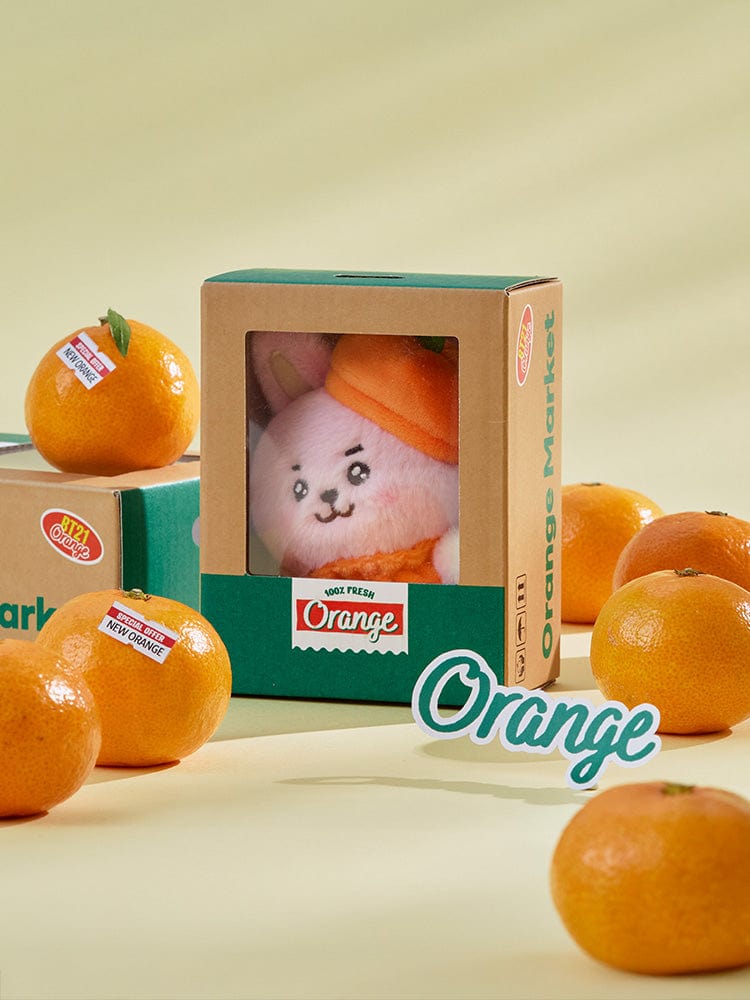 BT21 COOKY BABY PLUSH ORANGE PARTY : peluche Orange COOKY BT21 officielle LINE, dans son coffret, sur fond clair.