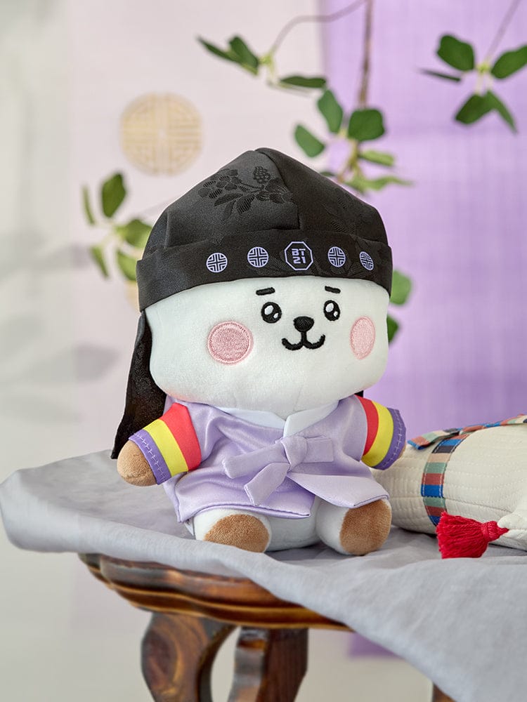 BT21 RJ BABY Premium K Edition Sitting Doll : peluche officielle LINE, RJ alpaga assis, déco chambre, fond violet fleurs.