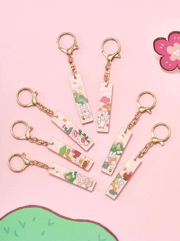 BT21 STICK ACRYLIC KEYRING K-TOKKI porte-clés acrylique LINE FRIENDS sur fond rose, personnages BT21 décoratifs