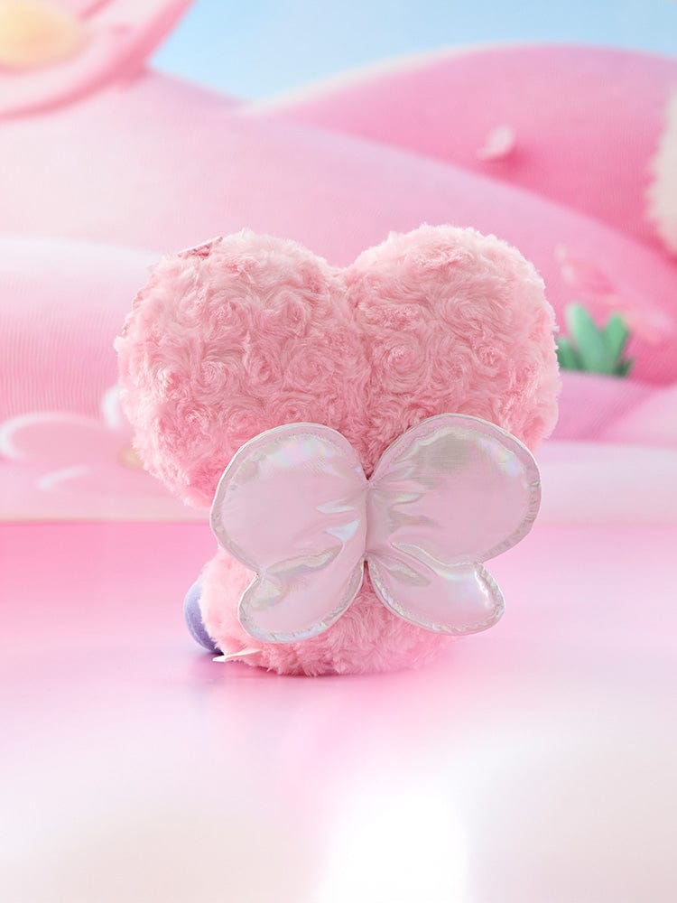 BT21 TATA BABY SITTING PLUSH SPRING FAIRY : peluche TATA assise rose, marque BT21, décor pastel lumineux en studio.