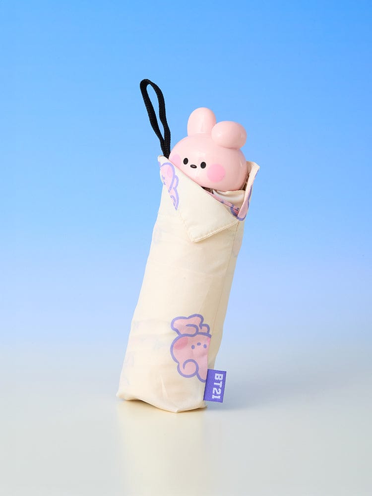 BT21 minini 3-TIER UMBRELLA RAINY DAY : parapluie compact officiel LINE FRIENDS avec figurine rose, fond bleu ciel.