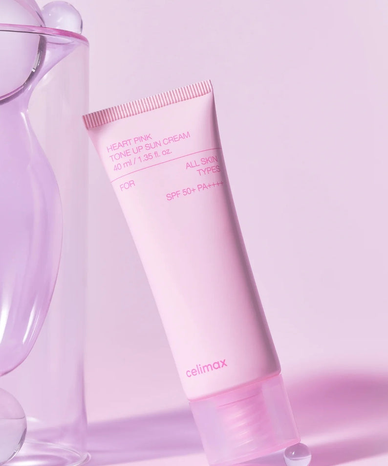 Crème solaire tonifiante CELIMAX Heart Pink Tone-up Sun Cream 40ml sur un fond rose élégant.