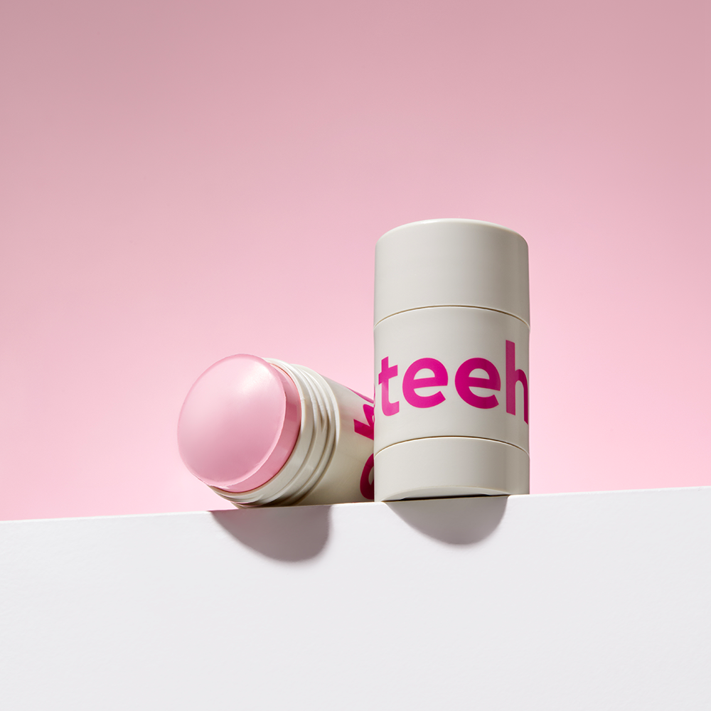 CHARMZONE Teeheehee Prtecting Beat Clay Mask Stick 35g, masque en stick sur fond rose pastel, flacon et étui ouvert