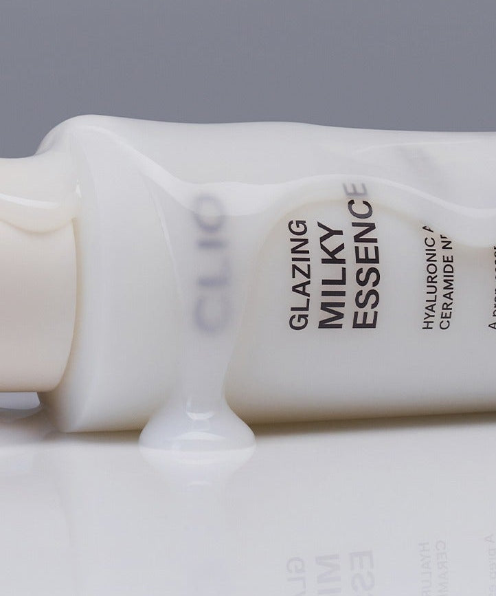 CLIO Glazing Milky Essence 120ml, flacon renversé avec essence laiteuse visible, produit de beauté hydratant et lissant.
