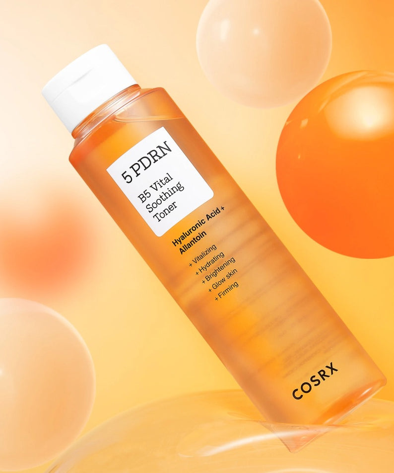 COSRX 5 PDRN B5 Vital Soothing Toner 100ml, flacon orange sur fond crème avec bulles lumineuses (visuel produit)